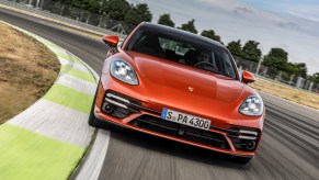 A burnt-orange 2021 Porsche Panamera travels on a racetrack