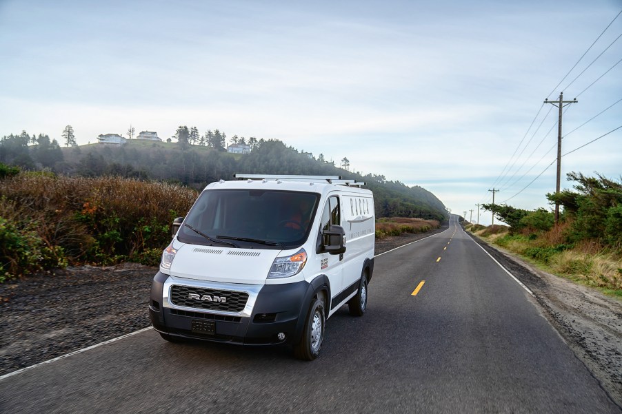 A white 2021 Ram ProMaster van on a rural two-lane road