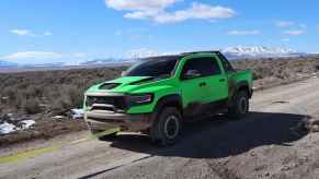 lime-green Ram TRX getting pulled off the trail after a break down