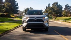 A silver 2021 Toyota RAV4 XLE front-wheel-drive compact crossover SUV on a suburban street