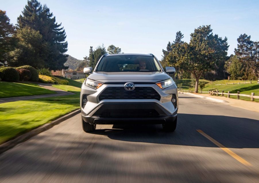 A silver 2021 Toyota RAV4 XLE front-wheel-drive compact crossover SUV on a suburban street