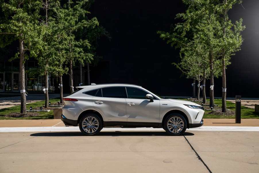 A white 2021 Toyota Venza XLE parked next to a grassy area with young trees