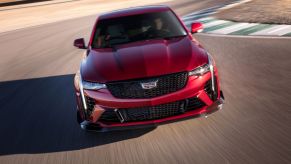 The front view of a red 2022 Cadillac CT4-V Blackwing on a racetrack