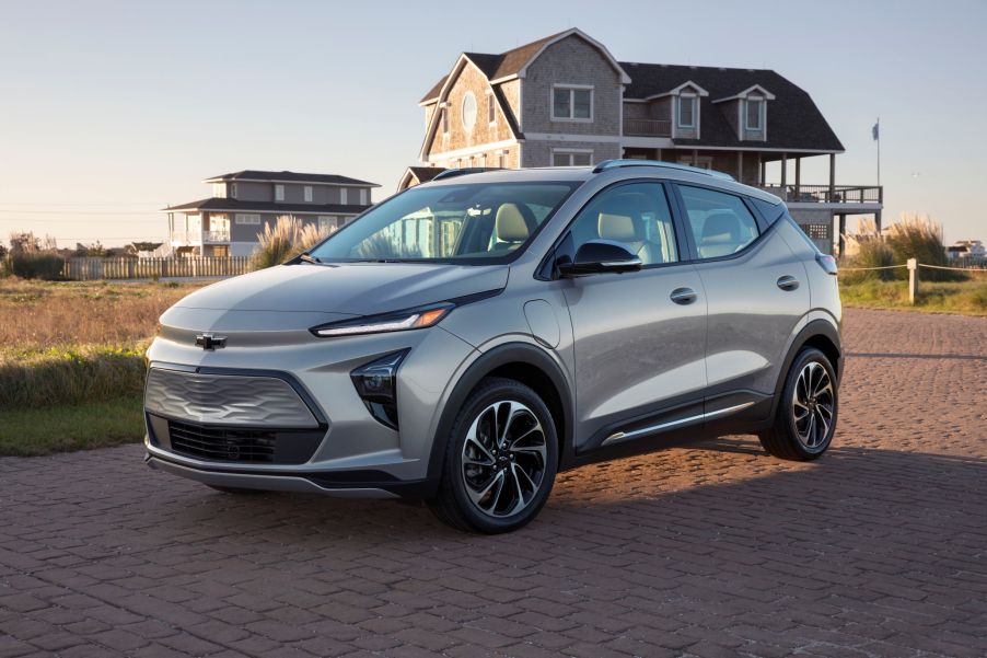 A silver 2022 Chevrolet Bolt EUV by a beach house at sunset