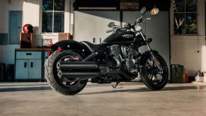 The rear 3/4 view of a black 2022 Indian Chief in a sunlit garage