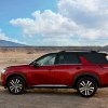 A red 2022 Nissan Pathfinder parked on a dirt road