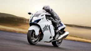 A black-clad rider on a white 2022 Suzuki Hayabusa on a track