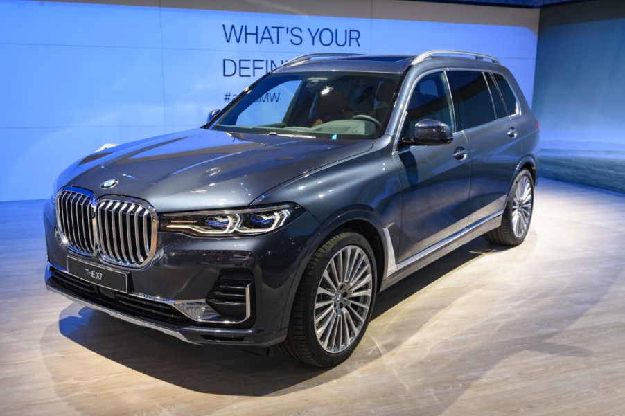 A blue BMW X7 on display at an auto show