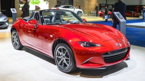 A red Mazda MX-5 Miata on display at an auto show