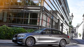 The 2021 BMW 530e parked in front of high-rise buildings on the street