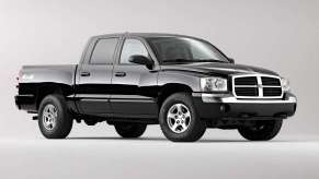 An image of a black 2005 Dodge Dakota parked inside of a photo studio.