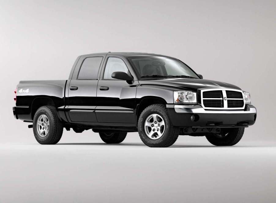 An image of a black 2005 Dodge Dakota parked inside of a photo studio.