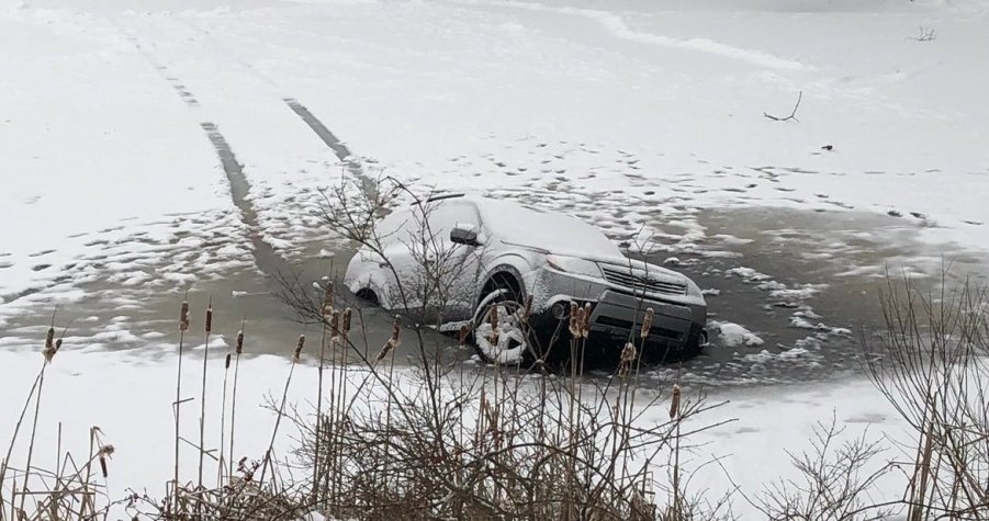 A Subaru Forester sinking through a frozen lake