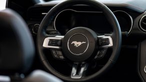 the steering wheel of a Ford Mustang on display at a dealership