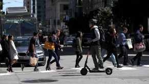 A person rides a Spin e-scooter in San Francisco