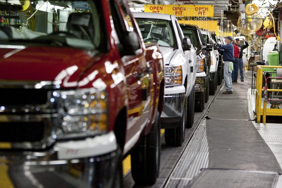 Chevy Silverado and GMC Sierra trucks being inspected on the assembly line