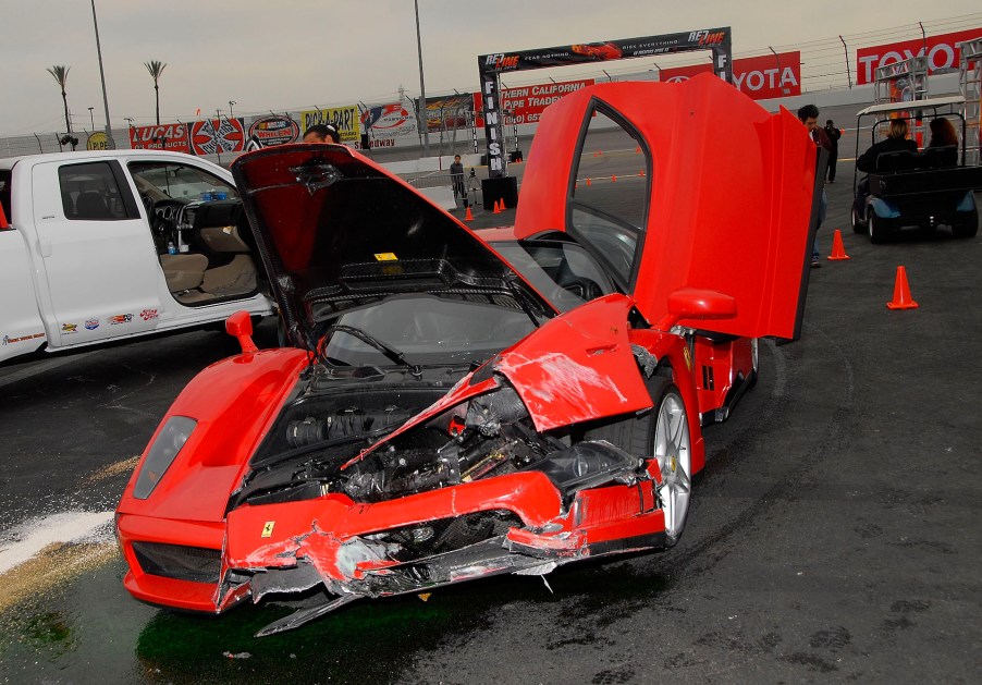 An image of a crashed Ferrari Enzo parked up on display.