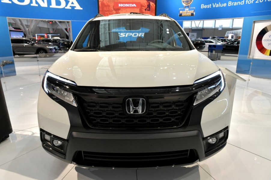 The front grille of a Honda Passport SUV on display an auto show