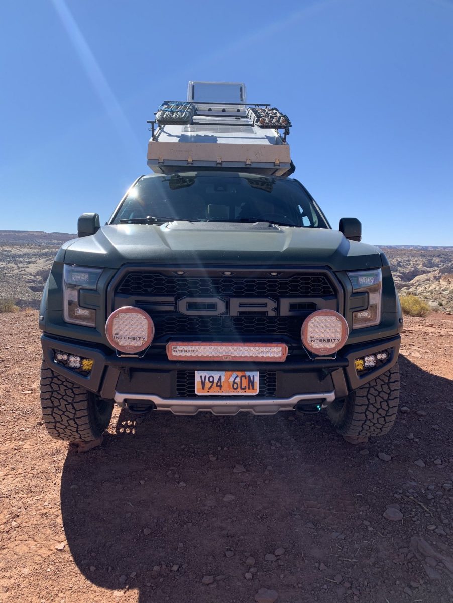 green 2018 Ford Raptor camper conversion in the desert