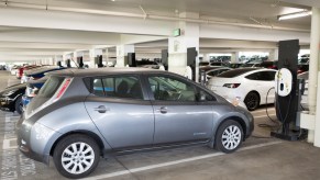 A Nissan Leaf electric car plugged into a charger