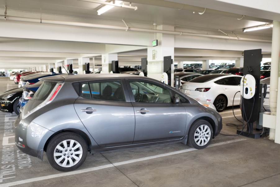 A Nissan Leaf electric car plugged into a charger