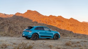 Miami Blue 2021 Porsche Macan GTS ripping through a canyon