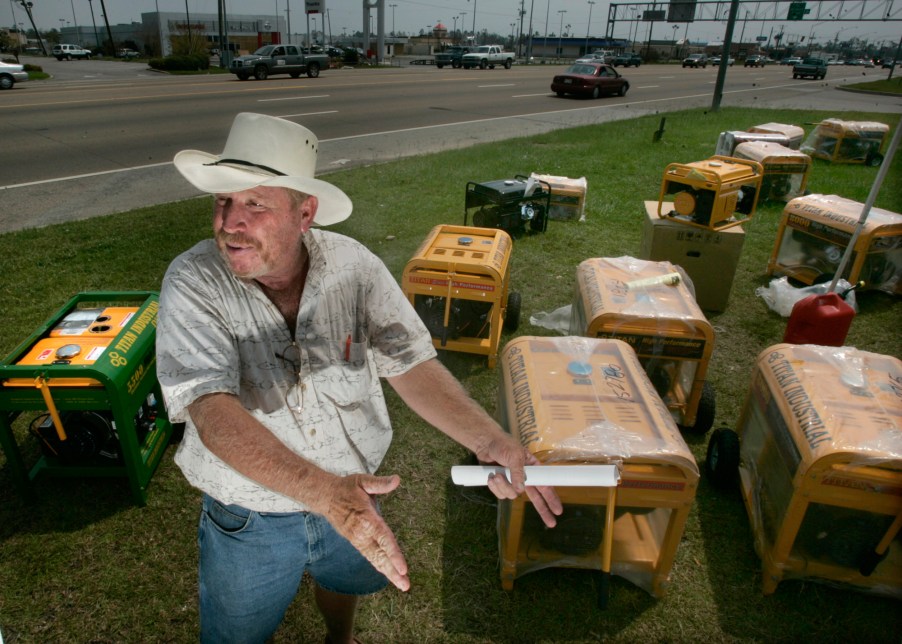 A man sets up some generators on display to sell them