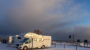 Motorhome RVs parked by the sea are seen in Mechelinki, Poland, on 6 February 2021