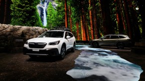 A white Subaru Outback on display at an auto show