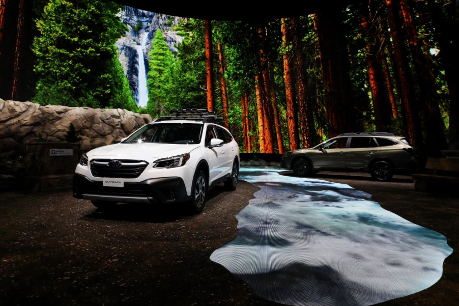 A white Subaru Outback on display at an auto show