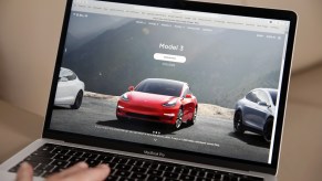 A person browsing Tesla Model 3 cars on the company's website