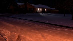 lone house with lights on in Texas power outage