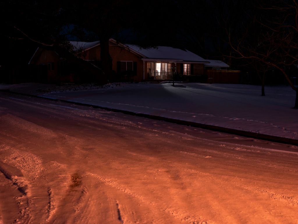 lone house with lights on in Texas power outage