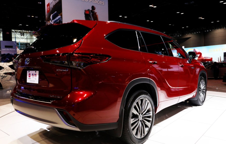 A red Toyota Highlander on display at an auto show