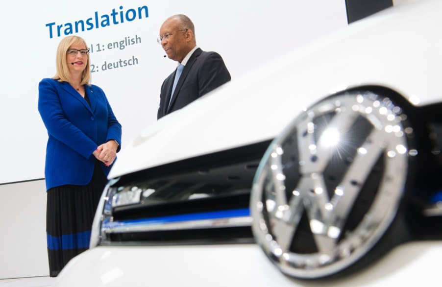 Two Volkswagen employees look on before a press conference