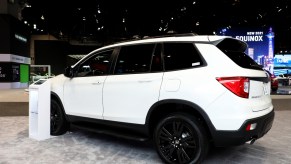 A white Honda Passport on display at an auto show