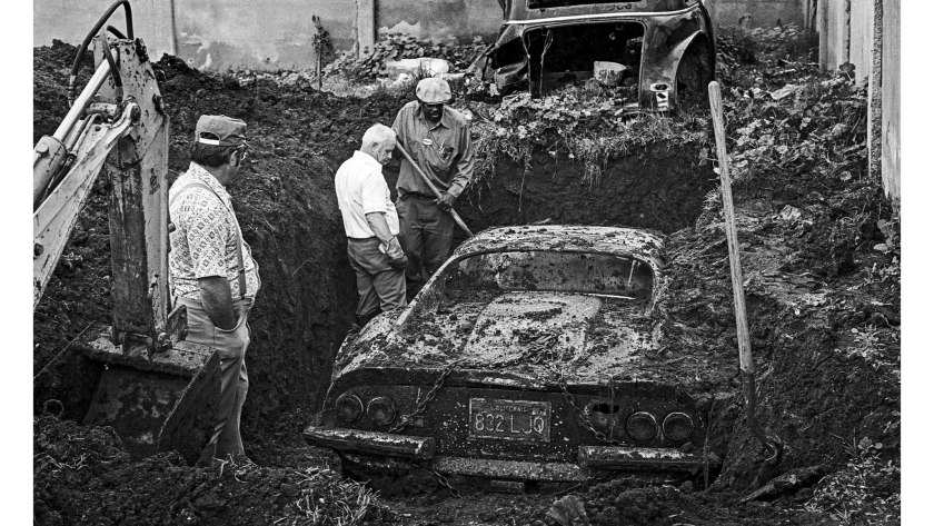 An image of a Ferrari Dino getting dug out of a hole in LA.