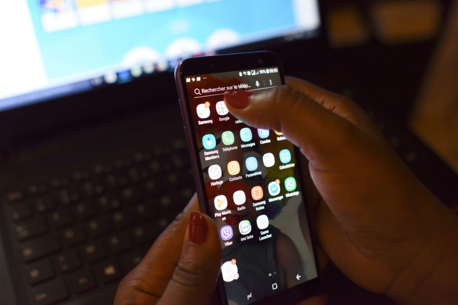 A person holds a smartphone up to receive a phone call