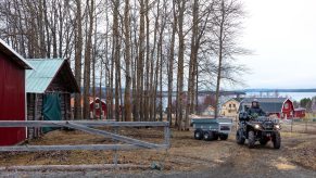 The 2021 Can-Am Outlander towing on a farm