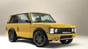 An image of a yellow Range Rover Chieftain by Jensen International Automotive inside of a studio.