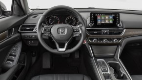 The black cockpit, including the steering wheel, of a 2018 Honda Accord Touring 2.0T sedan