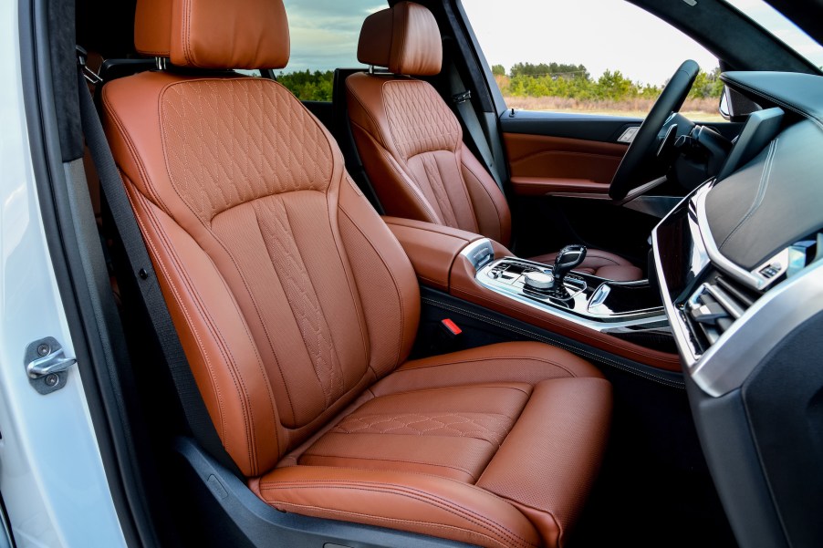 The quilted tan-leather front seats of a 2020 BMW X7 crossover SUV