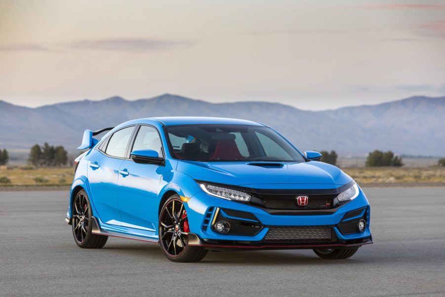 A blue 2020 Honda Civic Type R parked on display with a mountain range in the background