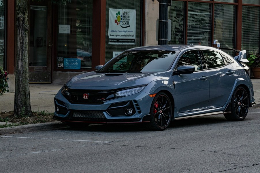 A gray 2020 Honda Civic Type R parked on the street by some shops