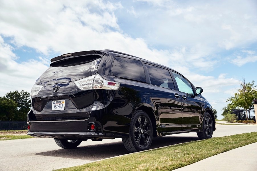 A black 2020 Toyota Sienna Nightshade minivan parked along a curb in a residential neighborhood