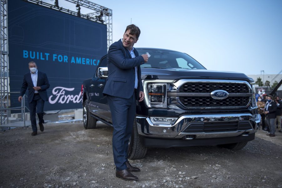 Ford CEO Jim Farley takes off his mask at the Ford Built for America event at Ford’s Dearborn Truck Plant