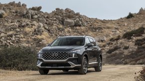 A black 2021 Hyundai Santa Fe Calligraphy parked in front of a rocky hill