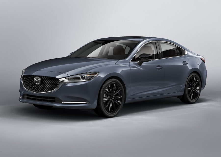 A grey 2021 Mazda6 Carbon Edition on display in front of a silver background