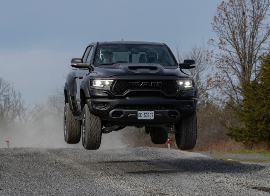 A black 2021 Ram 1500 TRX jumping through the air above a gravel road