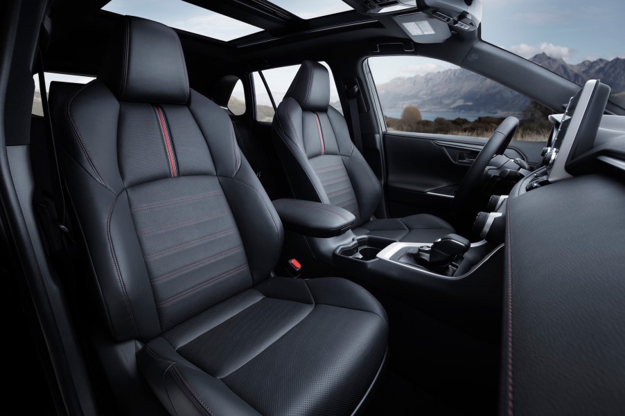 The interior of a 2021 Toyota RAV4 Prime hybrid compact crossover SUV with a panoramic sunroof and black-leather seating